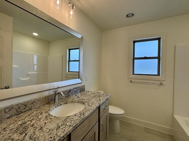 full bathroom featuring recessed lighting, vanity, toilet, and baseboards