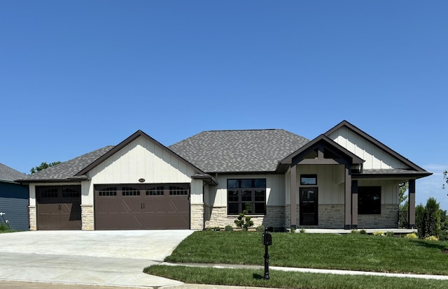 4605 Sawgrass Dr, Columbia, MO 65203 - view of front of home with a garage, board and batten siding, roof with shingles, and stone siding