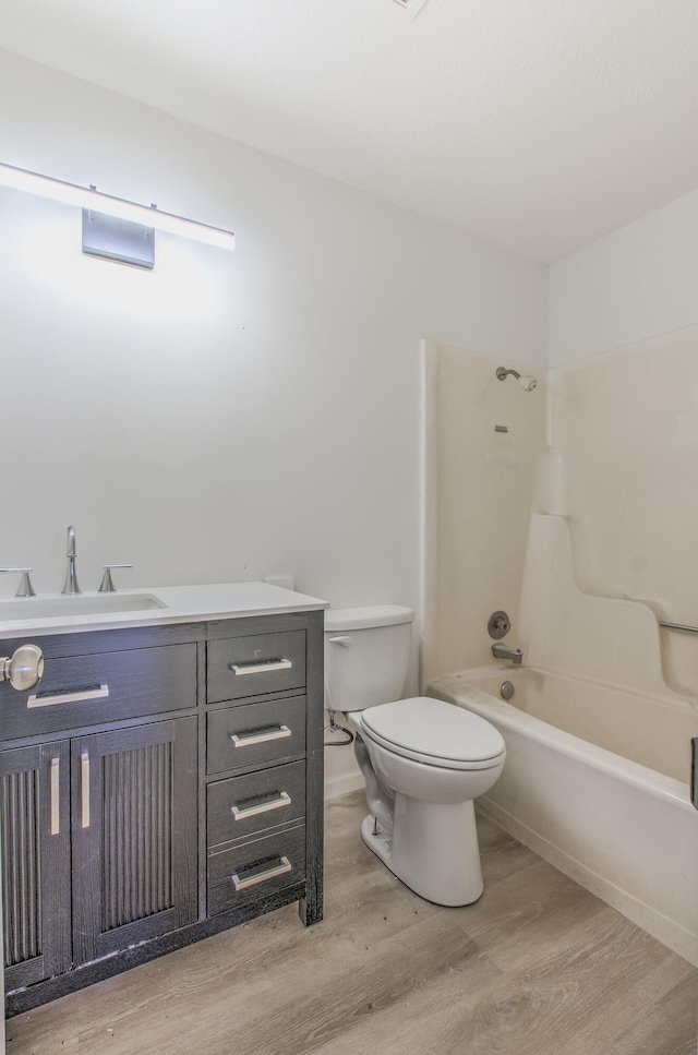 full bathroom featuring toilet, vanity, shower / bath combination, and hardwood / wood-style flooring