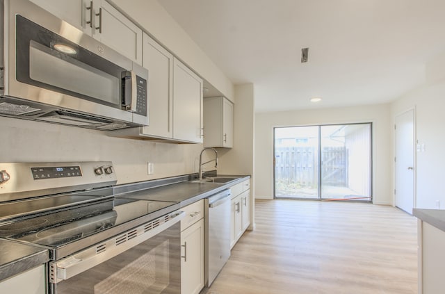 kitchen with white cabinets, sink, and appliances with stainless steel finishes