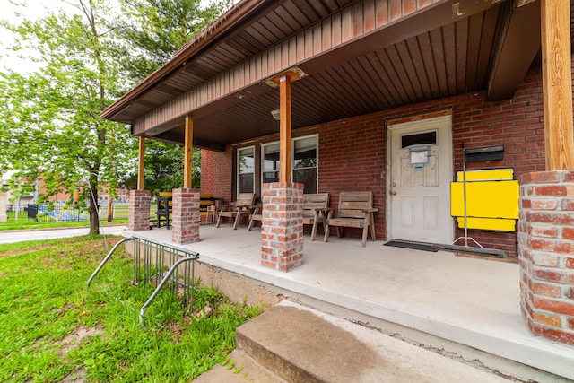 901 Range Line St, Columbia, MO 65201 - property entrance with brick siding, outdoor dining space, and covered porch