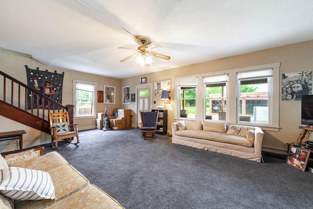 carpeted living room with a textured ceiling and ceiling fan