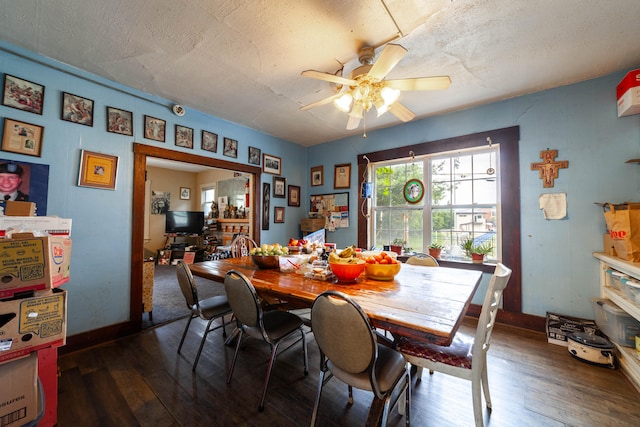 dining area featuring a textured ceiling, dark hardwood / wood-style flooring, and ceiling fan