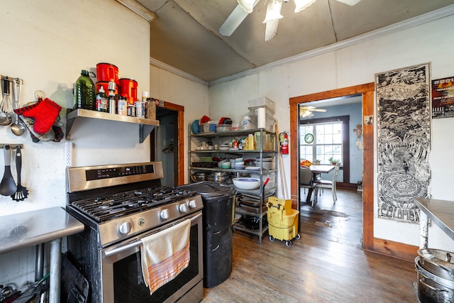 kitchen with stainless steel range with gas stovetop, ceiling fan, dark hardwood / wood-style floors, and crown molding