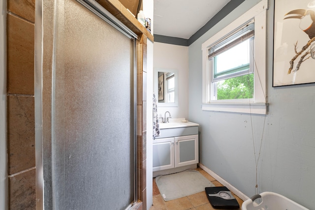 bathroom with walk in shower, vanity, and tile patterned floors