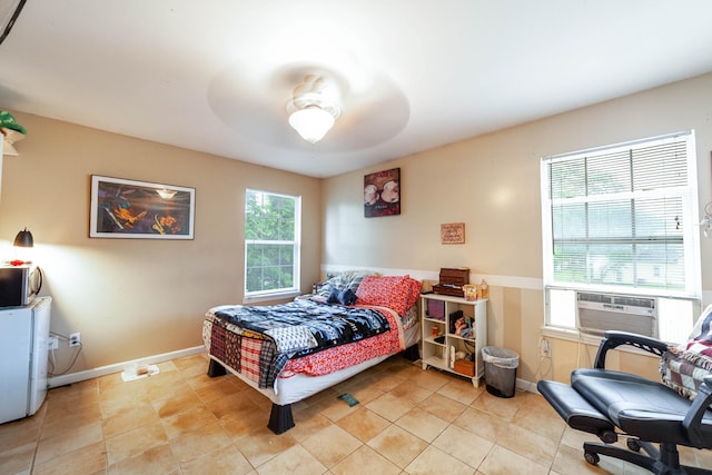 tiled bedroom featuring cooling unit and ceiling fan