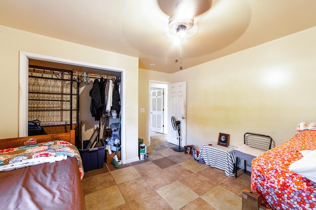 bedroom with ceiling fan and a closet