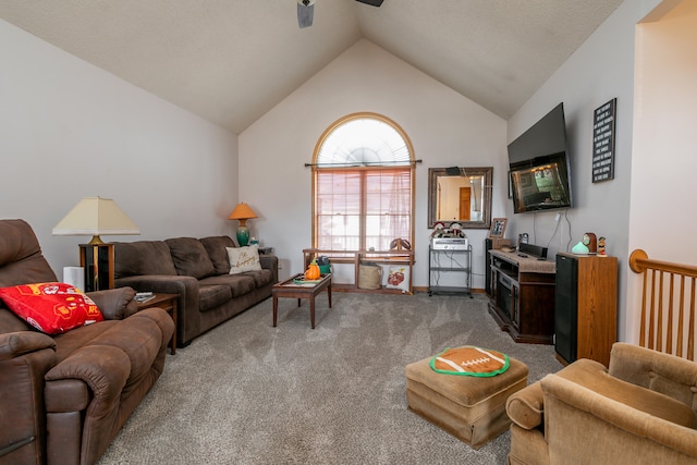 living room featuring carpet, ceiling fan, and vaulted ceiling