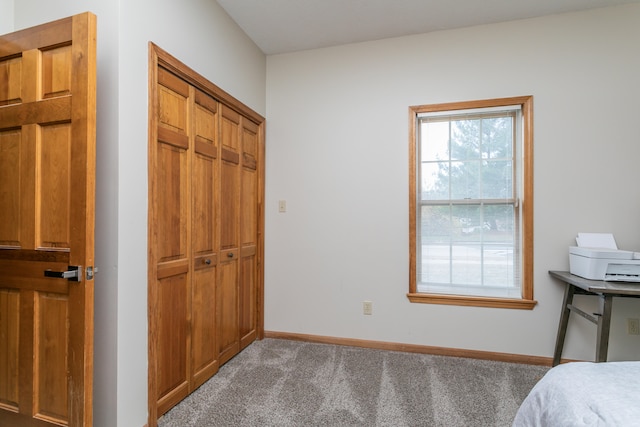 unfurnished bedroom with a closet and carpet flooring