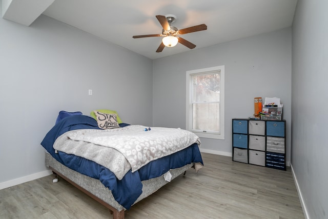 bedroom with hardwood / wood-style floors and ceiling fan