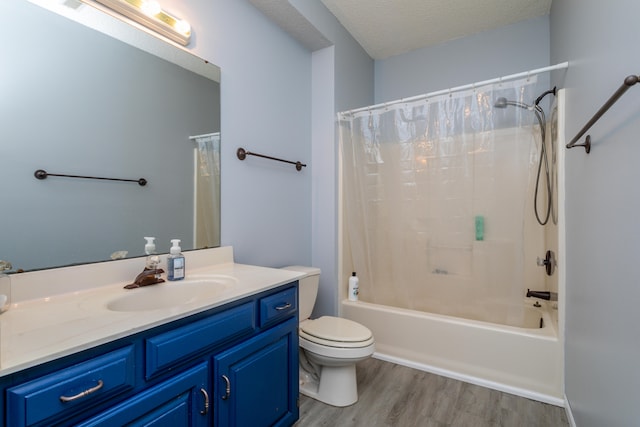 full bathroom with shower / bath combo with shower curtain, toilet, hardwood / wood-style flooring, a textured ceiling, and vanity