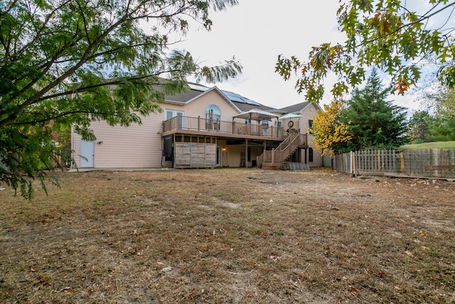 back of property featuring a wooden deck