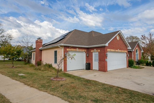 view of side of home with a garage and a yard