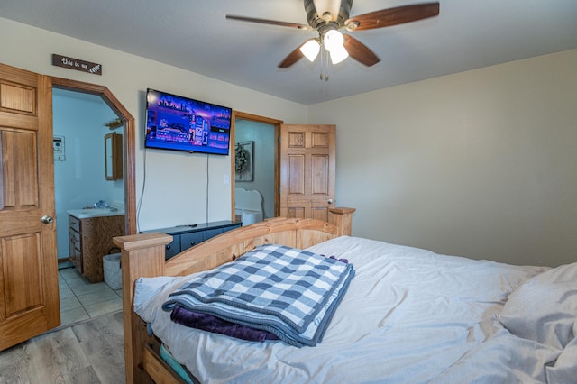 bedroom with light wood-type flooring, ceiling fan, and sink