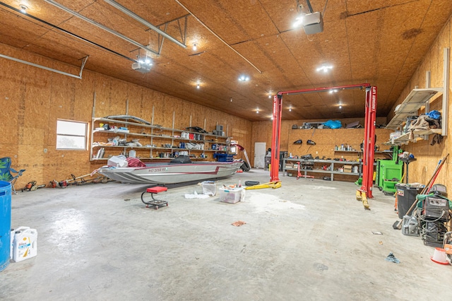 garage featuring wood walls and a workshop area