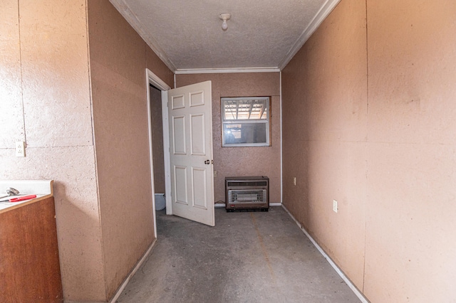 hallway with heating unit, concrete floors, and crown molding