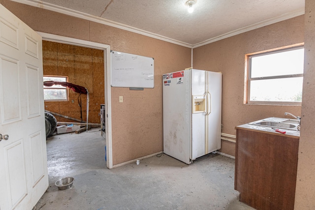 kitchen featuring sink, white refrigerator with ice dispenser, and crown molding