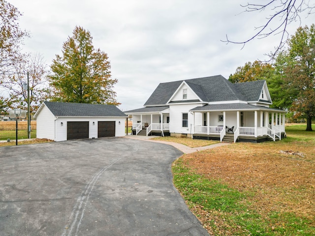 view of front of home with a porch, a garage, and an outdoor structure