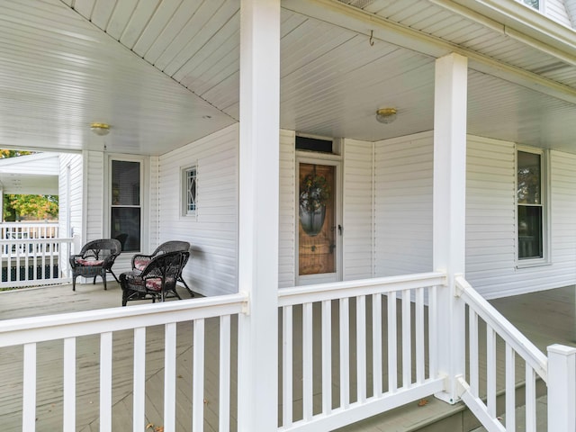 view of exterior entry featuring covered porch