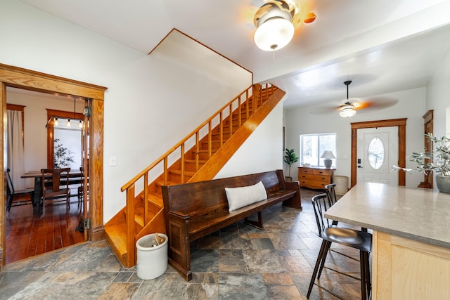231 State Route W, Fayette, MO 65248 - dining area featuring stone finish flooring, stairs, and a ceiling fan