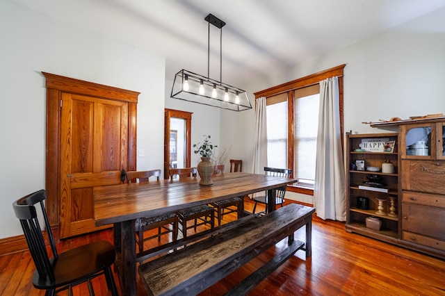 dining space with dark hardwood / wood-style floors