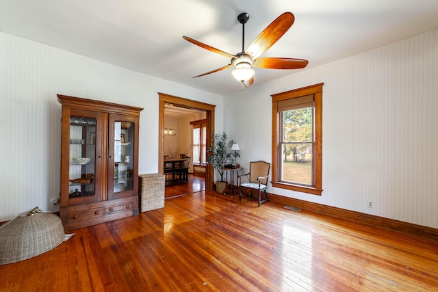 unfurnished room with hardwood / wood-style flooring and ceiling fan