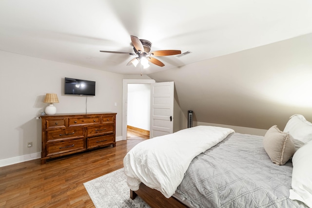 bedroom featuring wood-type flooring, ceiling fan, and lofted ceiling