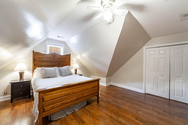 bedroom with ceiling fan, dark hardwood / wood-style floors, a closet, and lofted ceiling