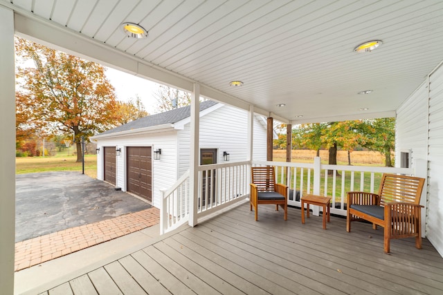 deck with a garage and an outdoor structure