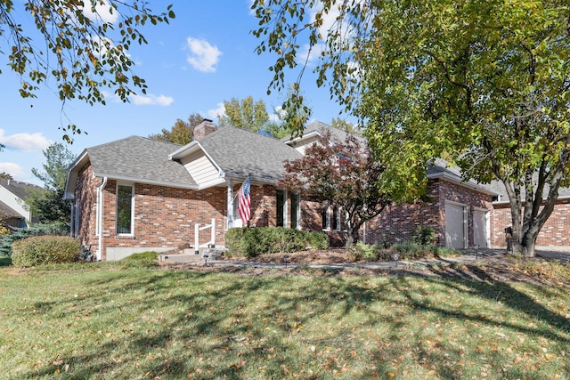 view of front of home with a garage and a front lawn