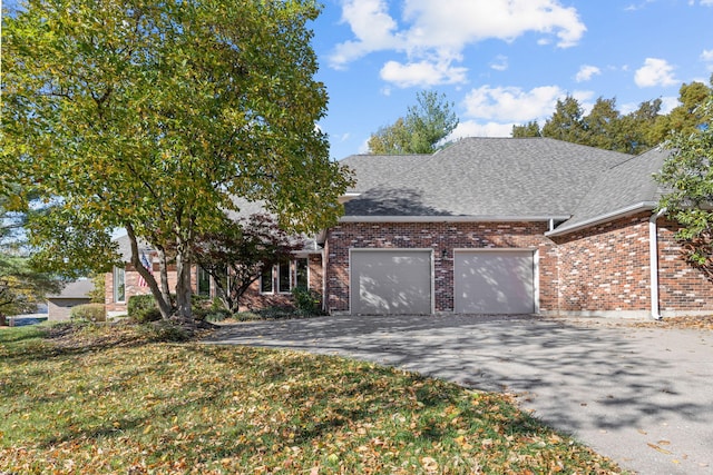 view of front of home featuring a garage and a front yard