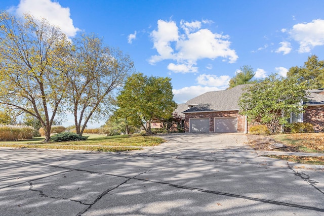 3405 Woodrail Ter, Columbia, MO 65203 - view of front of property featuring brick siding, driveway, an attached garage, and roof with shingles