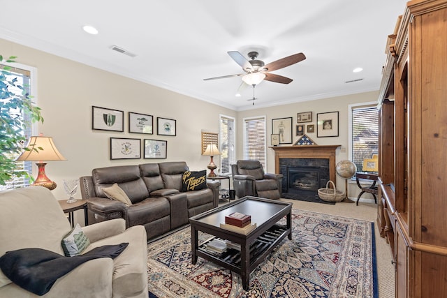 living room with carpet flooring, ceiling fan, and crown molding