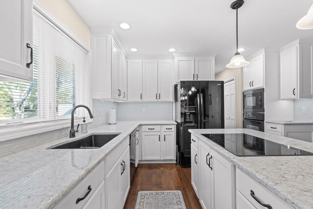 3405 Woodrail Ter, Columbia, MO 65203 - kitchen with a sink, black appliances, white cabinets, recessed lighting, and decorative light fixtures