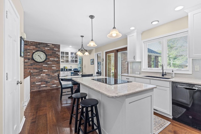 3405 Woodrail Ter, Columbia, MO 65203 - kitchen featuring black appliances, a sink, a center island, dark wood finished floors, and a kitchen breakfast bar