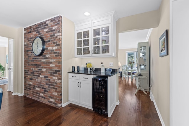 bar featuring white cabinets, dark hardwood / wood-style floors, and beverage cooler