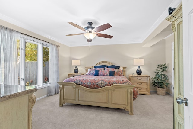 bedroom with ceiling fan, ornamental molding, and light colored carpet