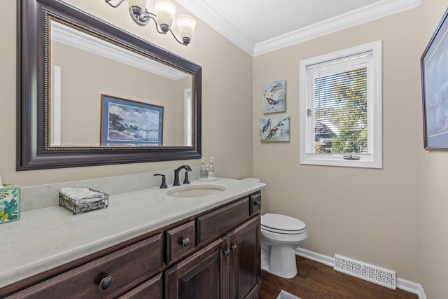 bathroom featuring ornamental molding, hardwood / wood-style floors, vanity, and toilet