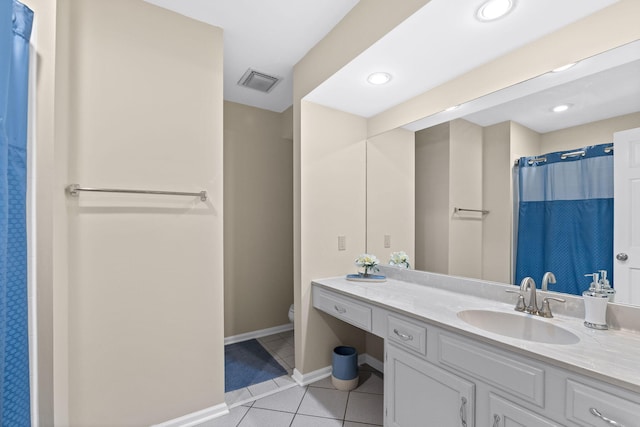 bathroom with curtained shower, vanity, tile patterned floors, and toilet