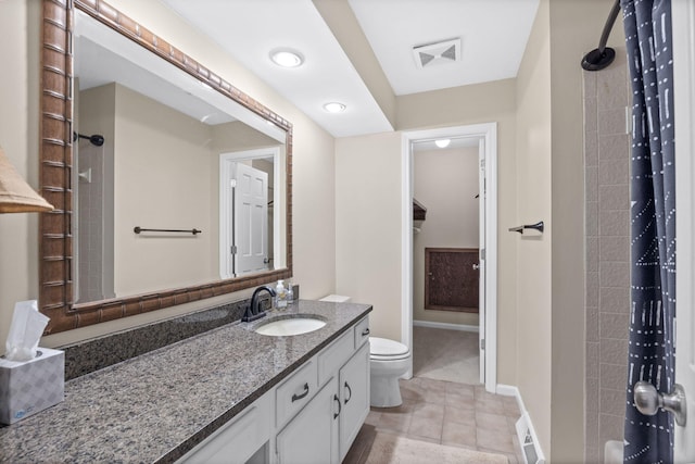 bathroom with toilet, vanity, tile patterned floors, and walk in shower