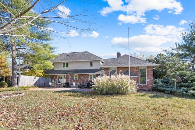 rear view of property with a patio area and a lawn