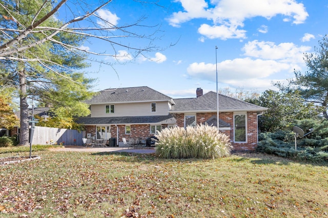 3405 Woodrail Ter, Columbia, MO 65203 - rear view of house featuring brick siding, a patio, a chimney, and a shingled roof