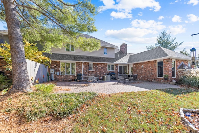 3405 Woodrail Ter, Columbia, MO 65203 - rear view of house featuring brick siding, a chimney, a patio area, and a shingled roof