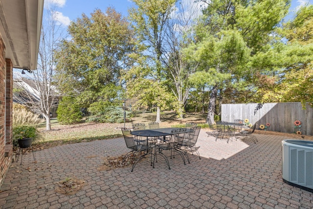 3405 Woodrail Ter, Columbia, MO 65203 - view of patio with outdoor dining area, central AC unit, and fence