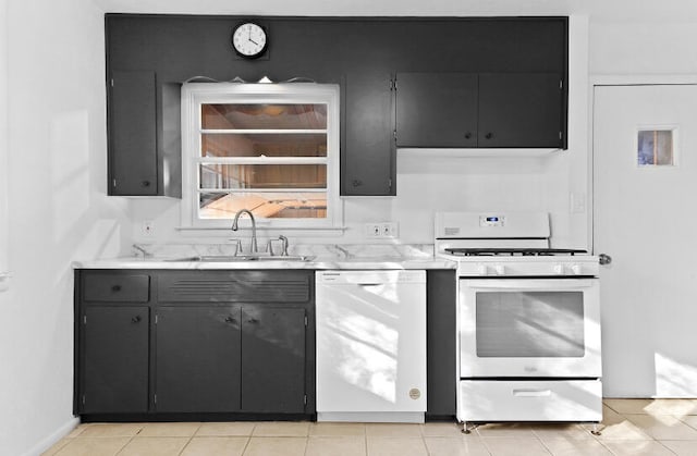 kitchen featuring light tile patterned floors, white appliances, and sink