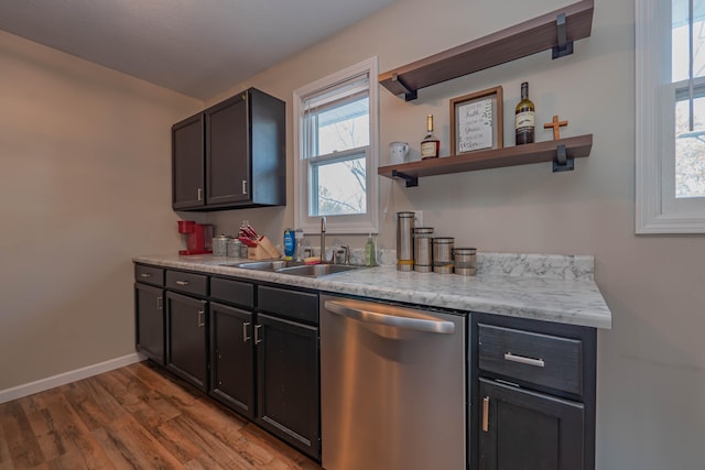 kitchen featuring dishwasher, sink, and light hardwood / wood-style flooring