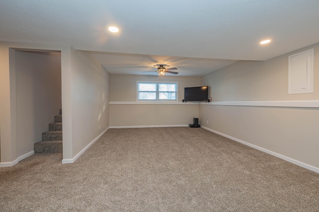 basement featuring ceiling fan and carpet floors