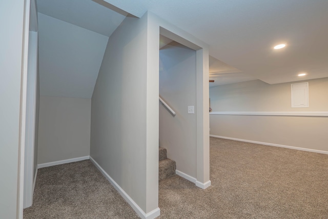 stairway with vaulted ceiling and carpet flooring