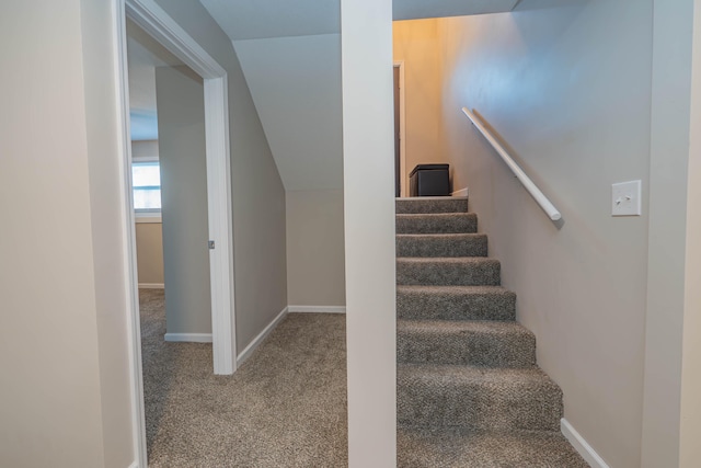 stairs with vaulted ceiling and carpet floors