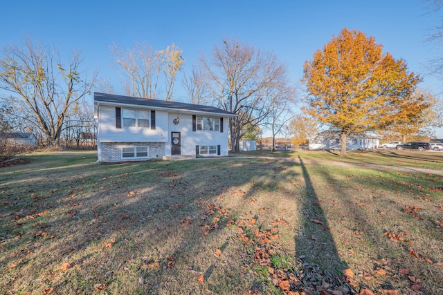 raised ranch with a front yard